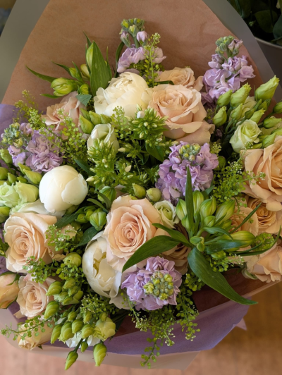 Peach & Lilac Bouquet - A beautifully handcrafted bouquet in soft peach, ivory and lilac tones, expertly arranged with seasonal flowers and fresh foliage.