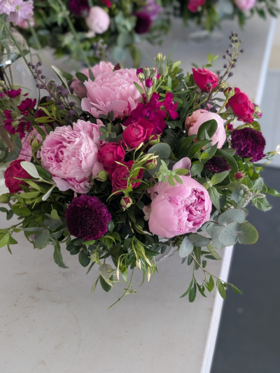 Petite Pink Vase - A charming petite vase arrangement featuring soft pink and rich cerise seasonal flowers with fresh foliage, expertly handcrafted for any occasion.